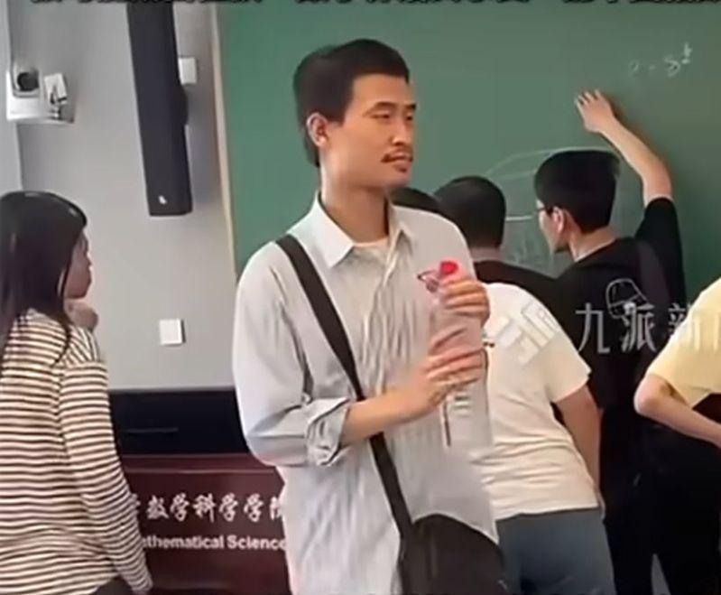 王虹(右二)与韦东奕(前排条纹衣)同框讨论数学问题。(视频截屏)