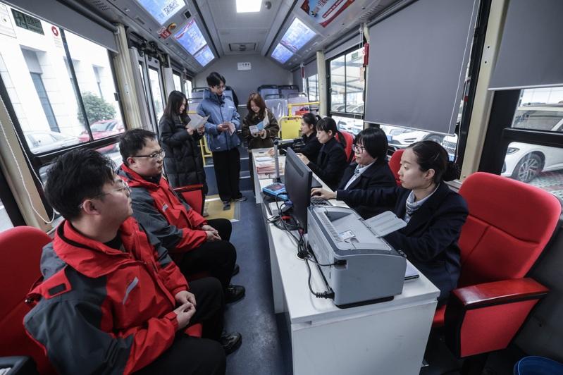 全面落实社保制度会对中国目前高失业率造成何种影响仍待观察。图为求职者排队等待面试。(新华社)