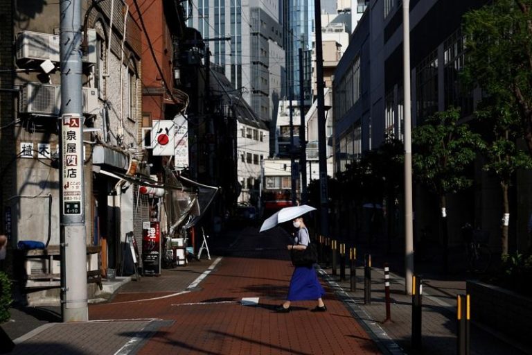 东京街头撑阳伞的行人。(路透)