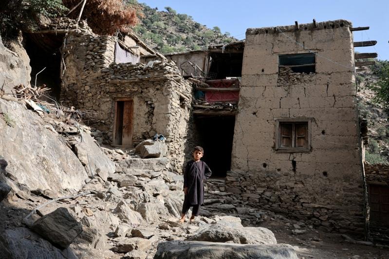 阿富汗发生强烈地震,当局称至少造成2200人罹难。图为4日一名男孩站在导她的房屋前。路透