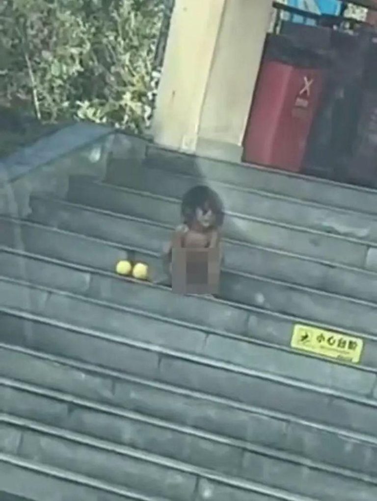 孩子全身赤裸，模仿动物蹲伏的动作。(视频截屏)