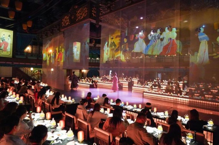 以大宋文化为创作背景的沉浸式宋文化主题餐秀「清明上河·宋宴」日前在河南开封清明上河园上演，吸引民众前来体验。图为裸眼3D光影呈现的古代画面吸引顾客观看。（中新社）