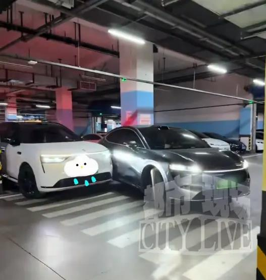 银灰色智界R7在倒车进车格时「挤」到了白色问界M8。(取材自都市现场)