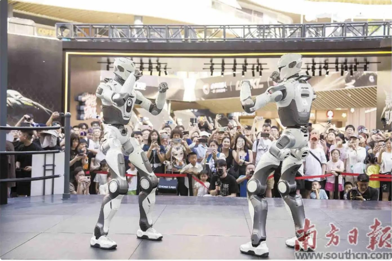 全球首场人形机器人格斗赛 头踢飞还在打 甄子丹:不可思议 两台众擎T800机器人在深圳商场打擂台赛。(取自南方日报)