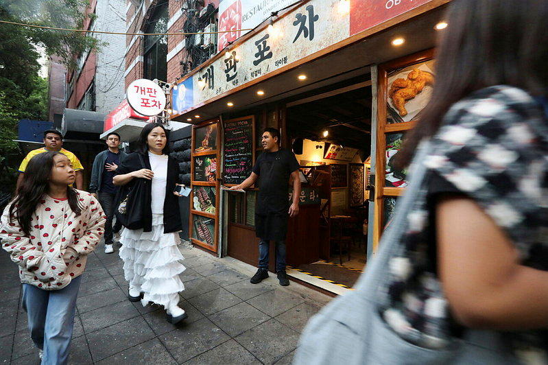 South Koreans walk past Gaepan Pocha res...